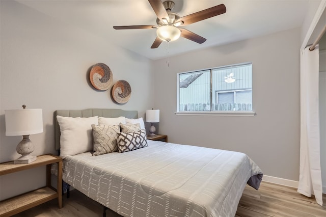 bedroom featuring light hardwood / wood-style flooring and ceiling fan