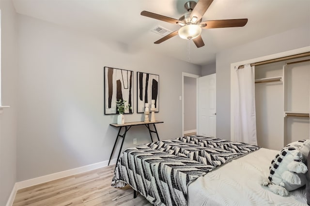 bedroom featuring ceiling fan, light hardwood / wood-style floors, and a closet