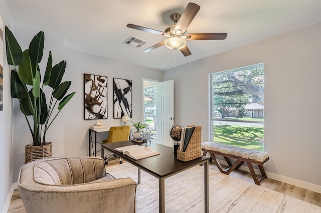 living area with ceiling fan and light hardwood / wood-style floors