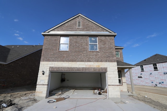 rear view of property with a garage