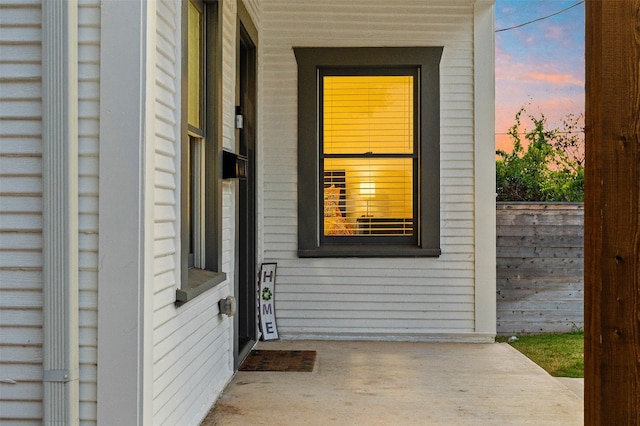 view of exterior entry at dusk