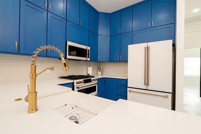 kitchen featuring blue cabinets, tasteful backsplash, and premium appliances