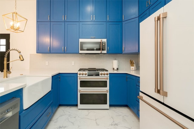 kitchen with decorative backsplash, high quality appliances, light tile patterned floors, blue cabinets, and sink