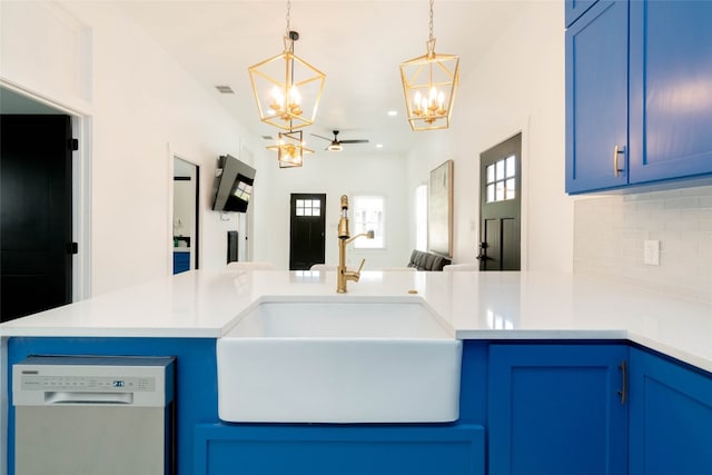 kitchen featuring blue cabinetry, dishwasher, tasteful backsplash, and sink