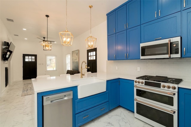 kitchen with stainless steel appliances, backsplash, light tile patterned floors, sink, and kitchen peninsula