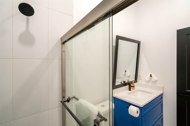 bathroom featuring tile walls, walk in shower, and vanity