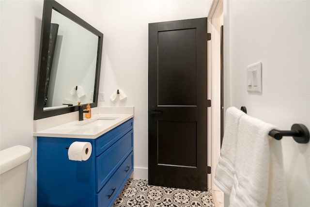 bathroom featuring toilet, tile patterned floors, and vanity