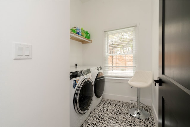 laundry area featuring tile patterned floors and washing machine and clothes dryer