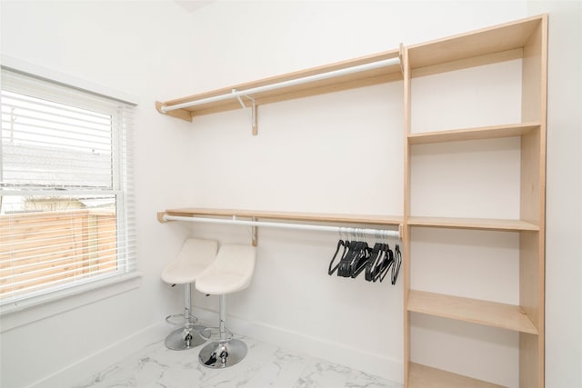 walk in closet with tile patterned floors