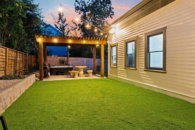 yard at dusk featuring a patio