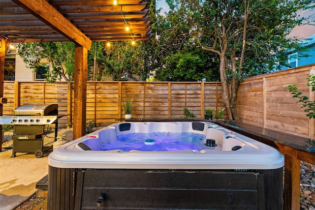 view of patio / terrace with a hot tub and a pergola