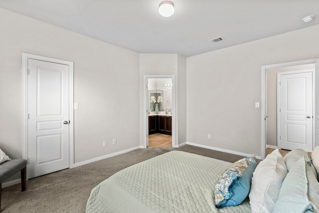 carpeted bedroom with ensuite bath