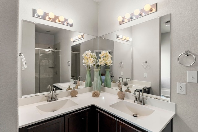 bathroom with vanity and a shower with shower door