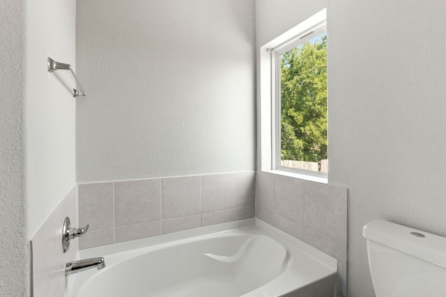 bathroom with a bathtub and toilet