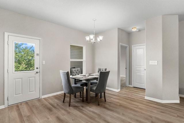 dining space with an inviting chandelier and light wood-type flooring