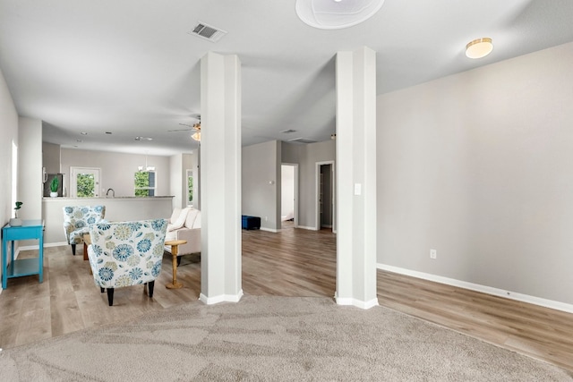 living room with ceiling fan and light hardwood / wood-style flooring