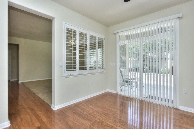 unfurnished room featuring hardwood / wood-style flooring