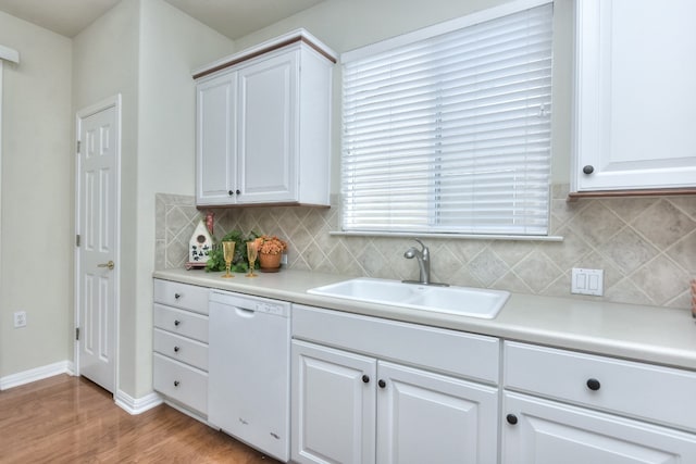 kitchen with white cabinets, dishwasher, sink, and light hardwood / wood-style flooring