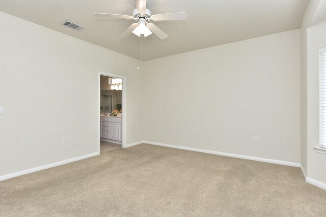 empty room with ceiling fan and light carpet