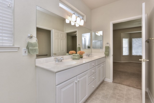 bathroom with dual vanity and tile patterned floors