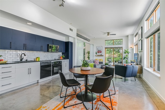 dining room featuring ceiling fan and sink