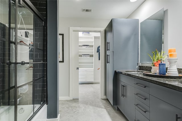 bathroom featuring vanity, concrete floors, and enclosed tub / shower combo