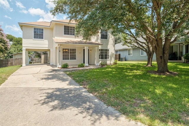 view of front of house with a front lawn and a carport