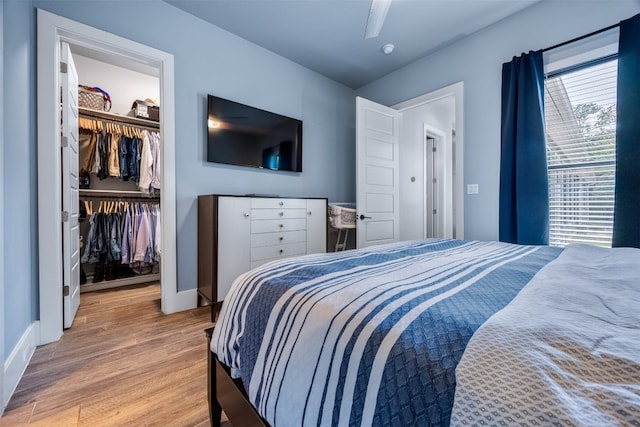 bedroom featuring ceiling fan, hardwood / wood-style flooring, and a closet