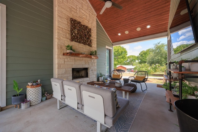 view of patio / terrace with an outdoor stone fireplace and ceiling fan