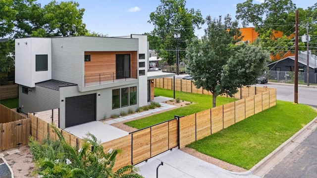 modern home with a balcony and a front yard