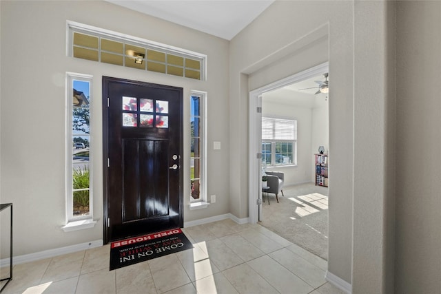 entrance foyer featuring ceiling fan and light tile patterned floors