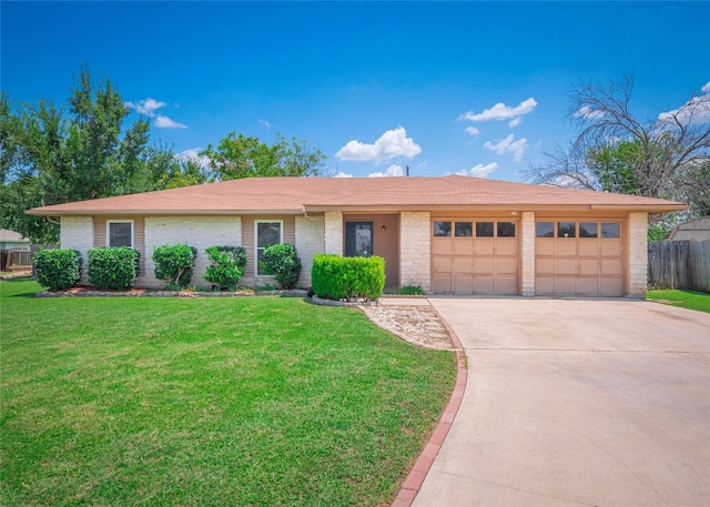 ranch-style house featuring a garage and a front lawn