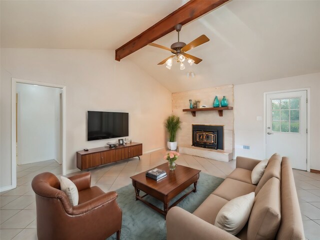 living room featuring a fireplace, lofted ceiling with beams, light tile patterned floors, and ceiling fan