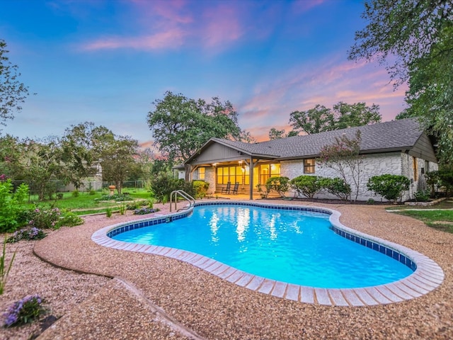 view of pool at dusk