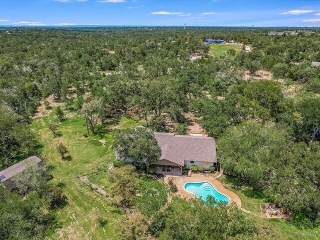 653 Leisure Ln, Cedar Creek, TX 78612 - bird's eye view of a pool and a heavily wooded area