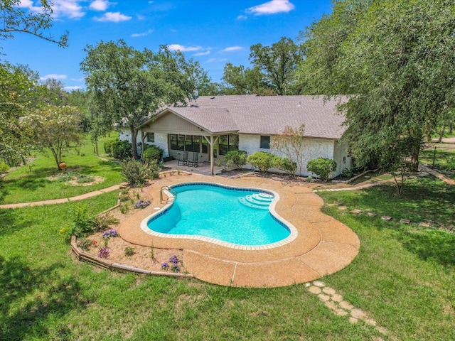 view of swimming pool with a lawn and a patio area