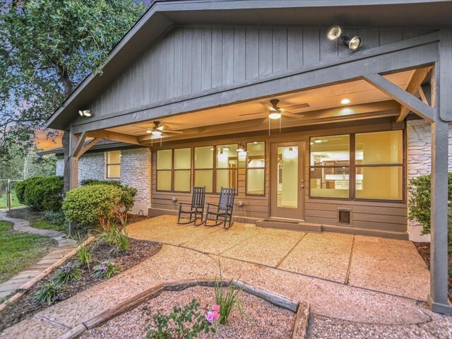 653 Leisure Ln, Cedar Creek, TX 78612 - back of property featuring a ceiling fan, a patio area, stone siding, and board and batten siding
