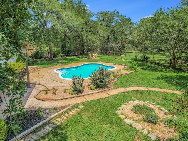 view of swimming pool with a lawn