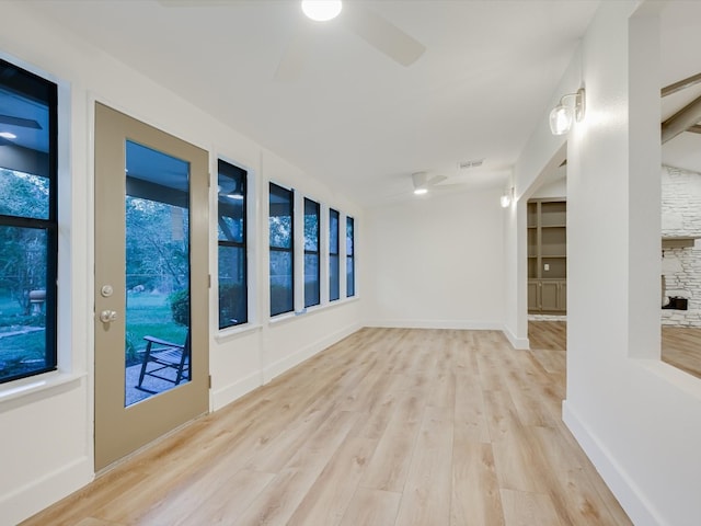 empty room with ceiling fan and light hardwood / wood-style floors