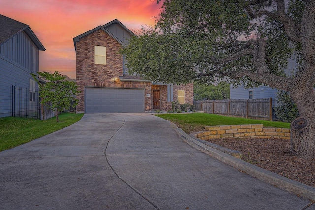 view of front of home with a yard and a garage