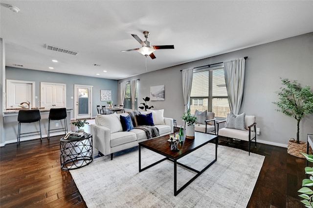 living room with ceiling fan and dark hardwood / wood-style floors