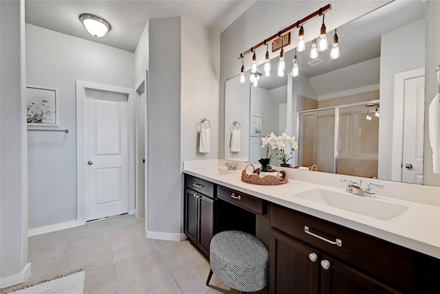 bathroom with vanity, walk in shower, and tile patterned floors