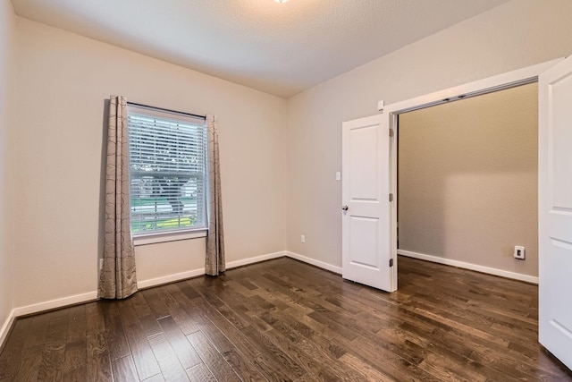 unfurnished bedroom featuring dark hardwood / wood-style floors