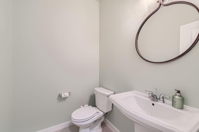 bathroom featuring sink and toilet