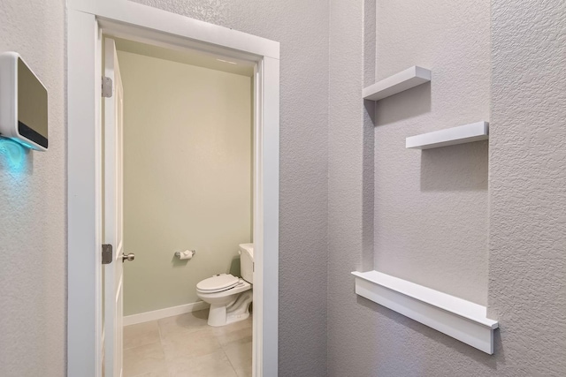 bathroom with toilet and tile patterned floors