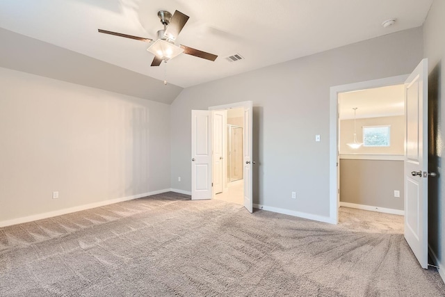 unfurnished bedroom with ceiling fan, carpet, and vaulted ceiling