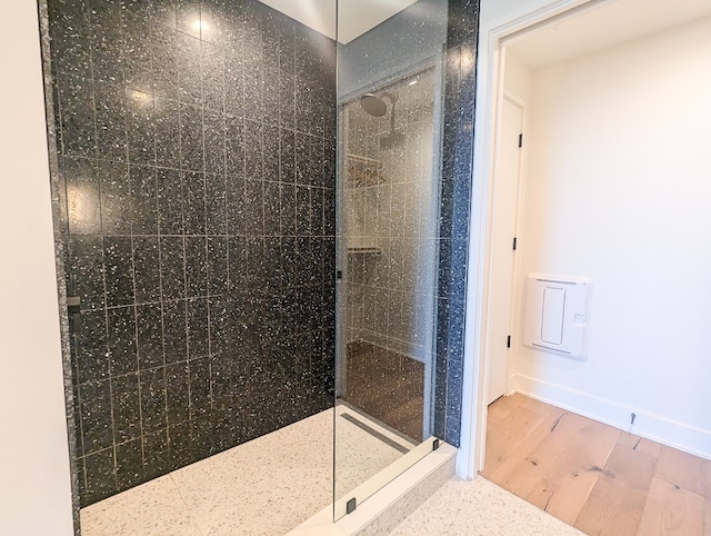 bathroom with walk in shower and wood-type flooring