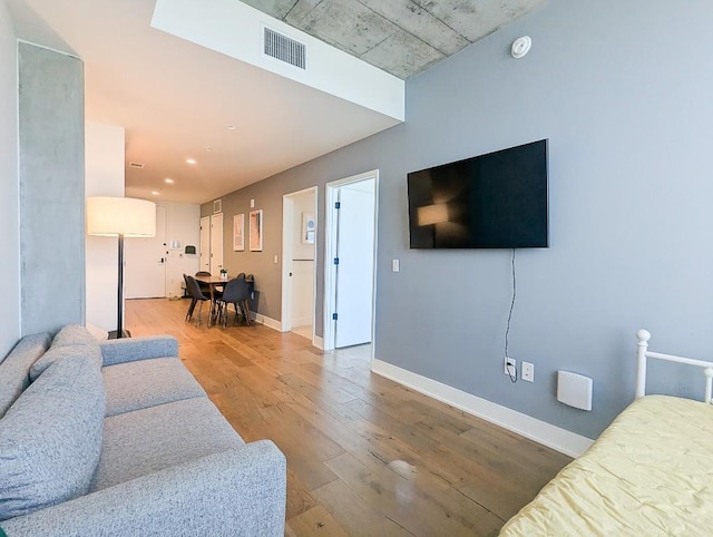 48 E Ave Unit 2405, Austin, TX 78701 - living room featuring wood finished floors and baseboards