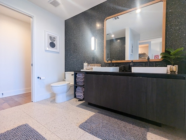 bathroom with hardwood / wood-style floors, vanity, and toilet