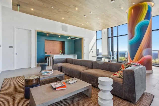 living room featuring wooden ceiling and expansive windows